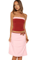 Close up of a two tone strapless fitted top in red and pink a trendy choice for a Summer evening out
