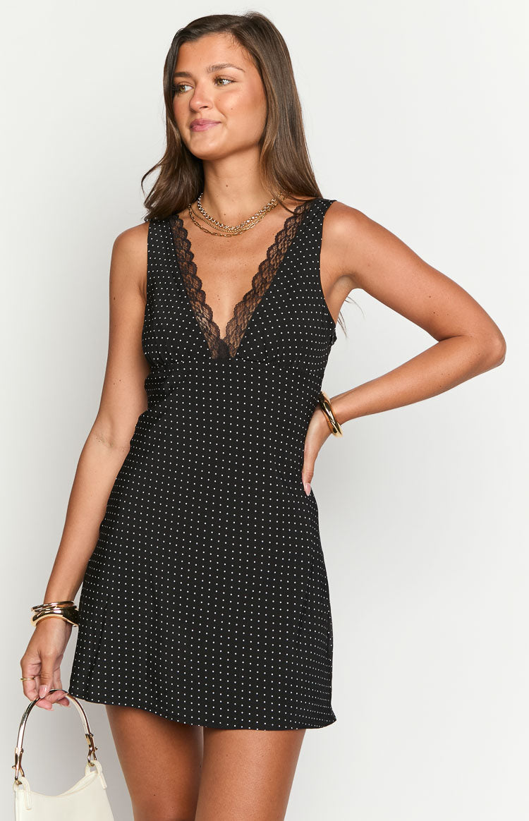 Black polka dot mini dress with a V-neckline and black lace trim