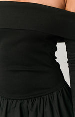 Close-up of the black ribbed off-shoulder neckline and fitted bodice above the gathered skirt of the mini dress