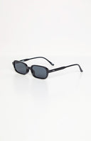 girl wearing black rectangle frame sunglasses with smokey black lenses