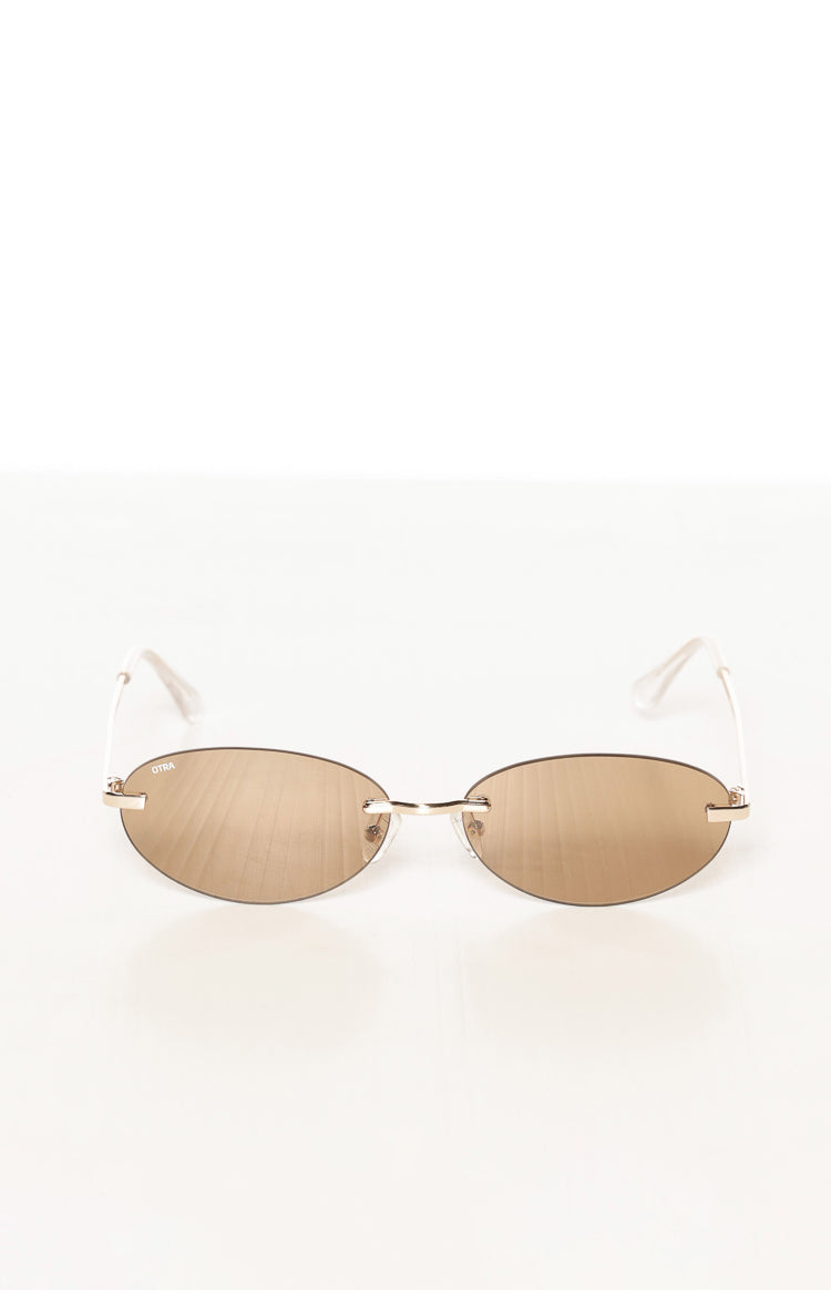 Front view of brown gold mirrored rimless oval sunglasses with a thin gold metal bridge and OTRA logo