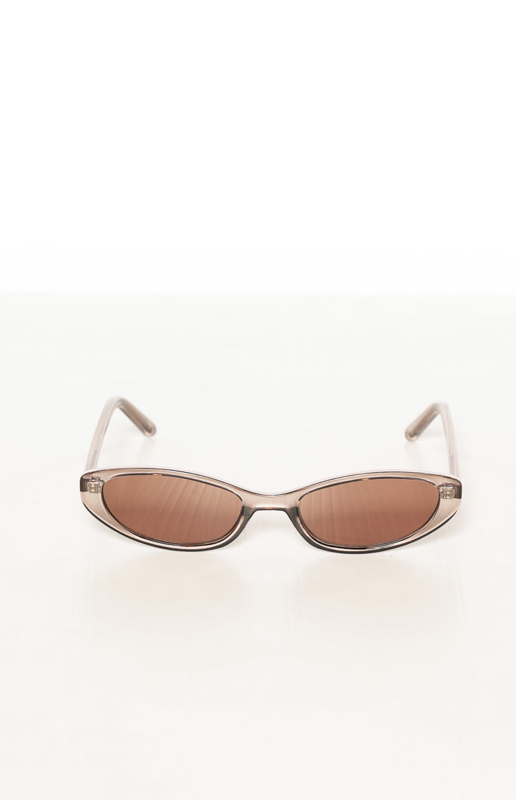 Translucent olive brown cat eye sunglasses with brown lenses from a slightly elevated front view