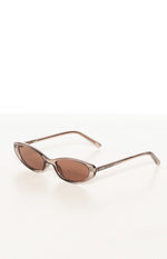 Angled view of translucent brown cat eye sunglasses with slim frames and dark brown lenses
