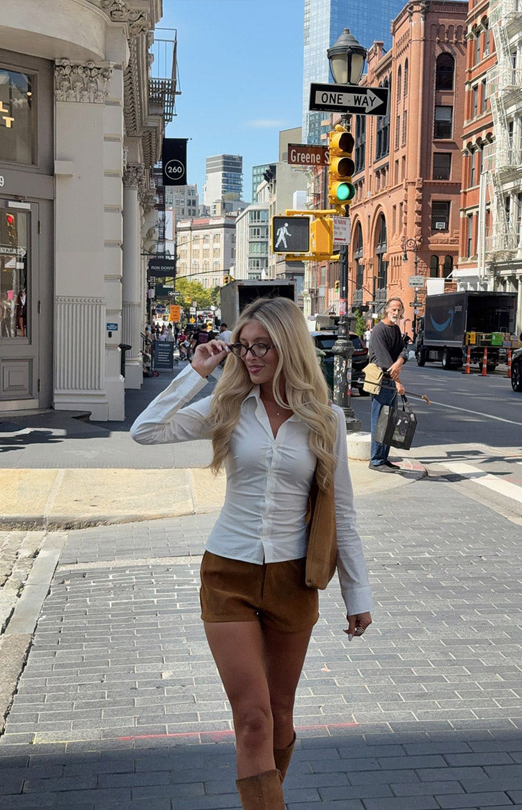 Tan suedette shorts with a fitted short length and visible texture