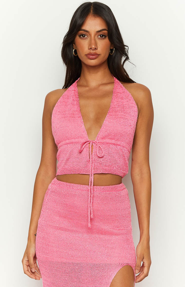 Front view of the pink knit crop top showing the deep V-neck halter and tie-front detail