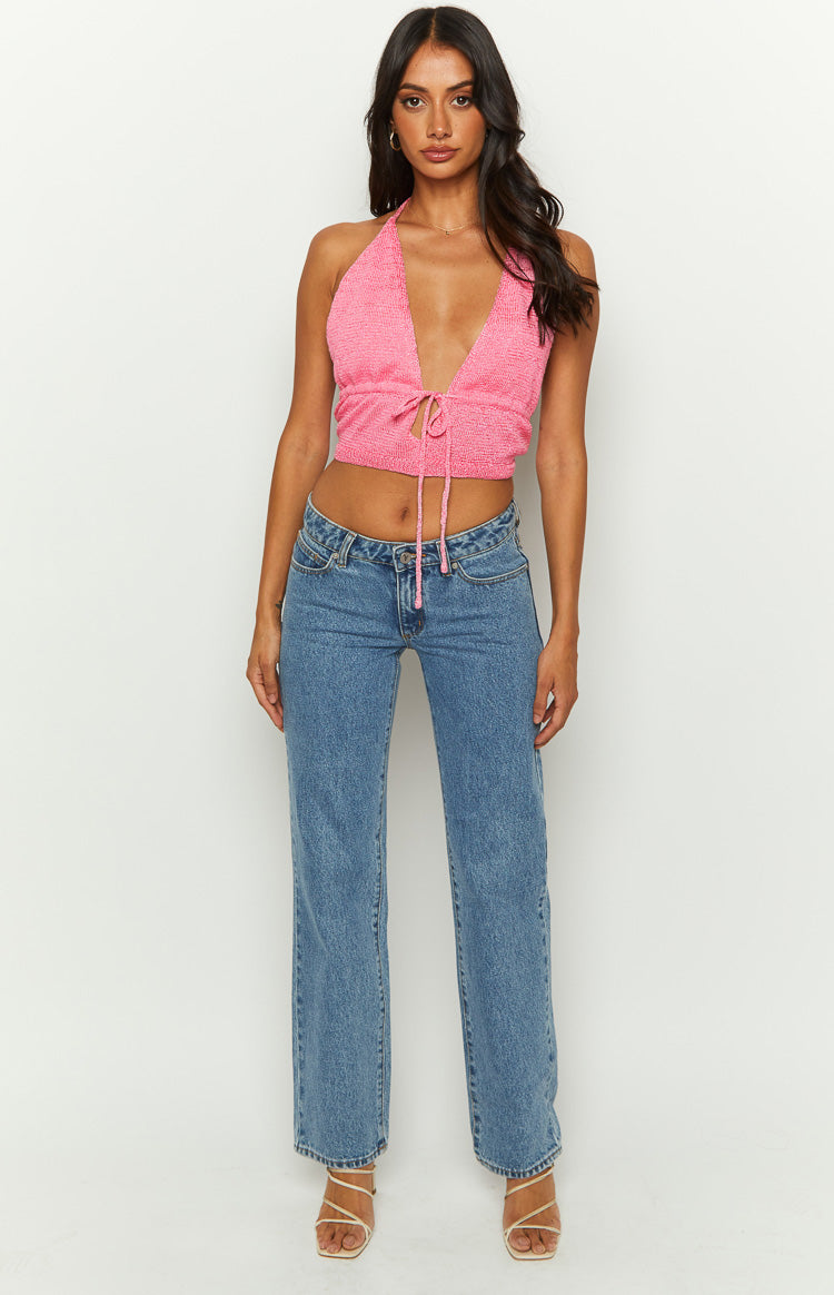 Pink knit halter crop top with deep V-neckline and adjustable tie-front detail