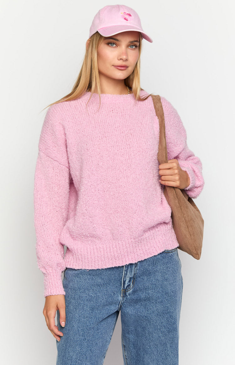 Front view of a pink textured knit sweater with a relaxed fit and ribbed crew neck