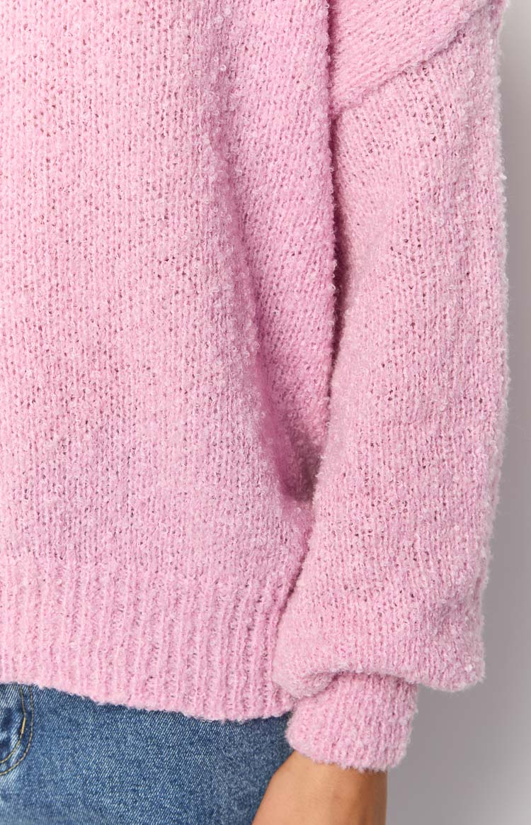 Close-up of the fluffy pink knit texture with ribbed hem and long sleeve cuff