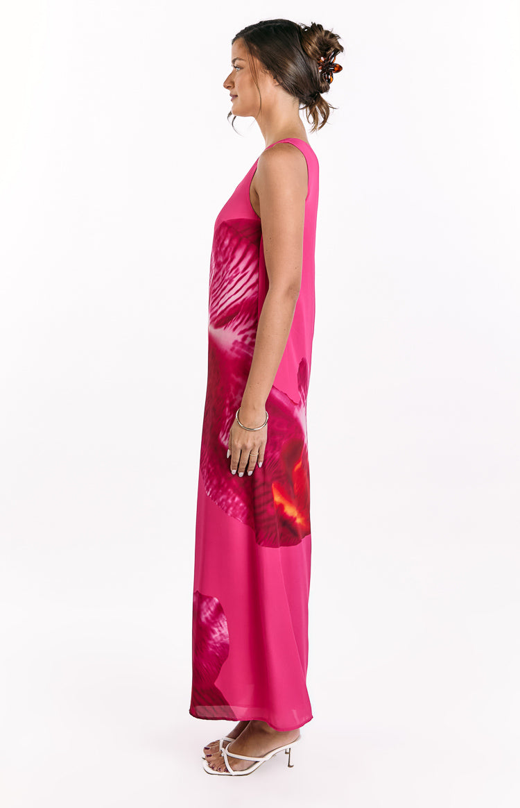 Side view of a pink orchid print maxi dress with a relaxed, flowy silhouette and sleeveless design