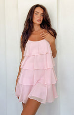 Front view of a light pink sheer tiered ruffle mini dress with thin spaghetti straps and a scoop neckline