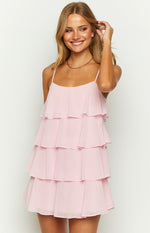 Front view of the light pink tiered ruffle mini dress with a square neckline and thin spaghetti straps