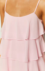 Close-up of the light pink tiered ruffles and thin spaghetti straps on a mini dress