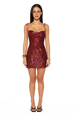Red sequin mini dress with a sweetheart neckline, tie-shoulder spaghetti straps, and abstract sequin pattern