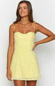 Front view of a yellow sequin mini dress with a sweetheart neckline and tie-up spaghetti straps