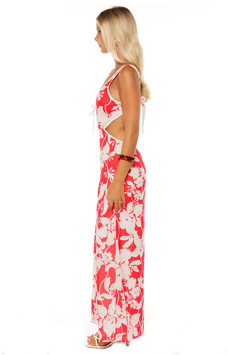 Side view of a red and white floral maxi dress with side waist cut-outs and tie shoulder details