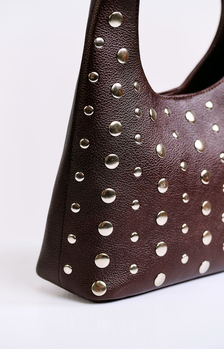 Close-up of the chocolate pebbled PU bag with scattered silver studs of varying sizes