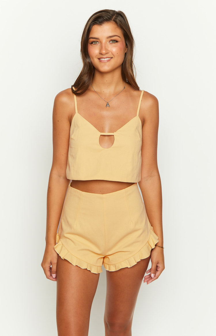 Petal yellow crop top with spaghetti straps, a V-neckline, and a circular cutout below the bust