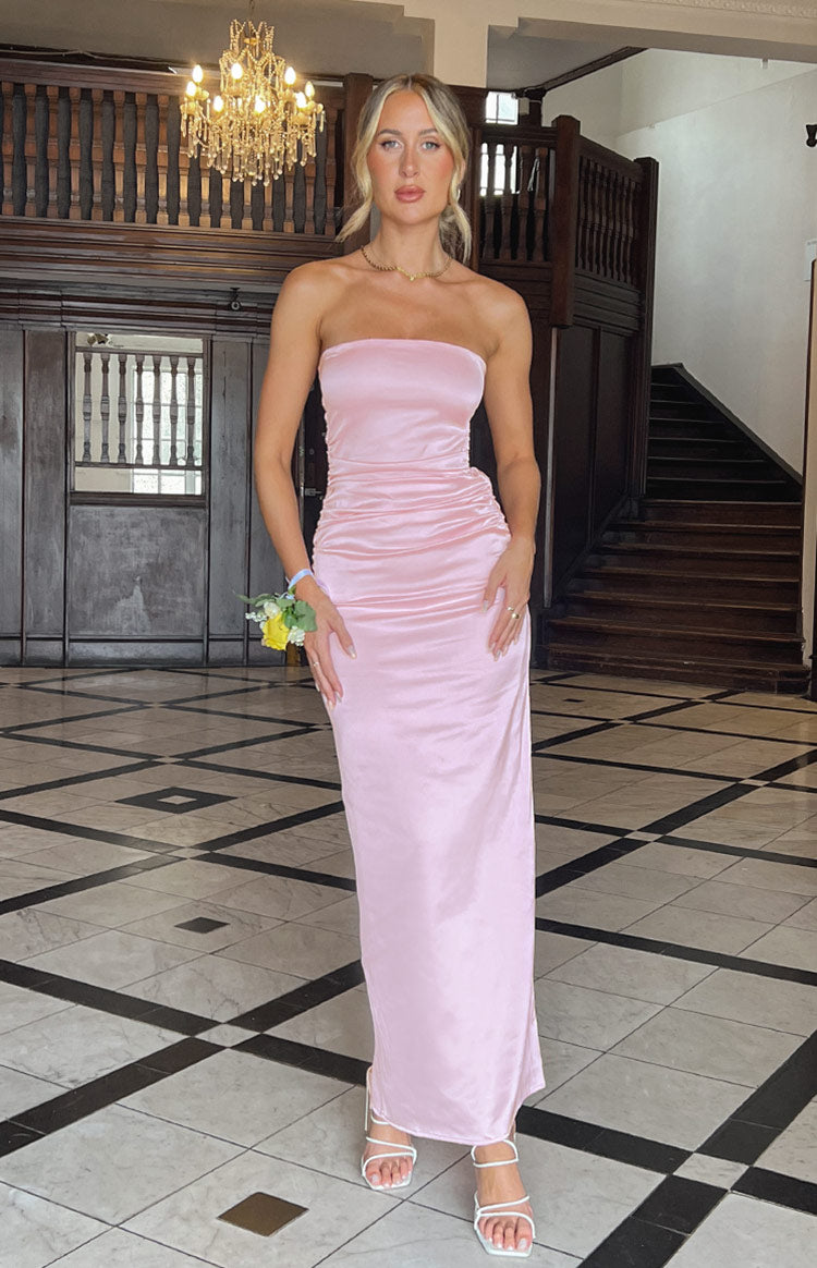 Full length front view of a pink satin strapless maxi dress with ruched detail on the left hip