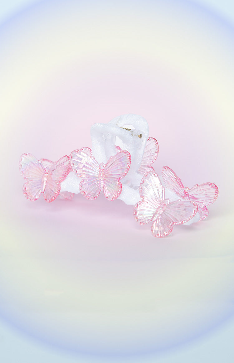Side view of the white claw clip with three iridescent pink butterflies, highlighting the textured wings and subtle shimmer