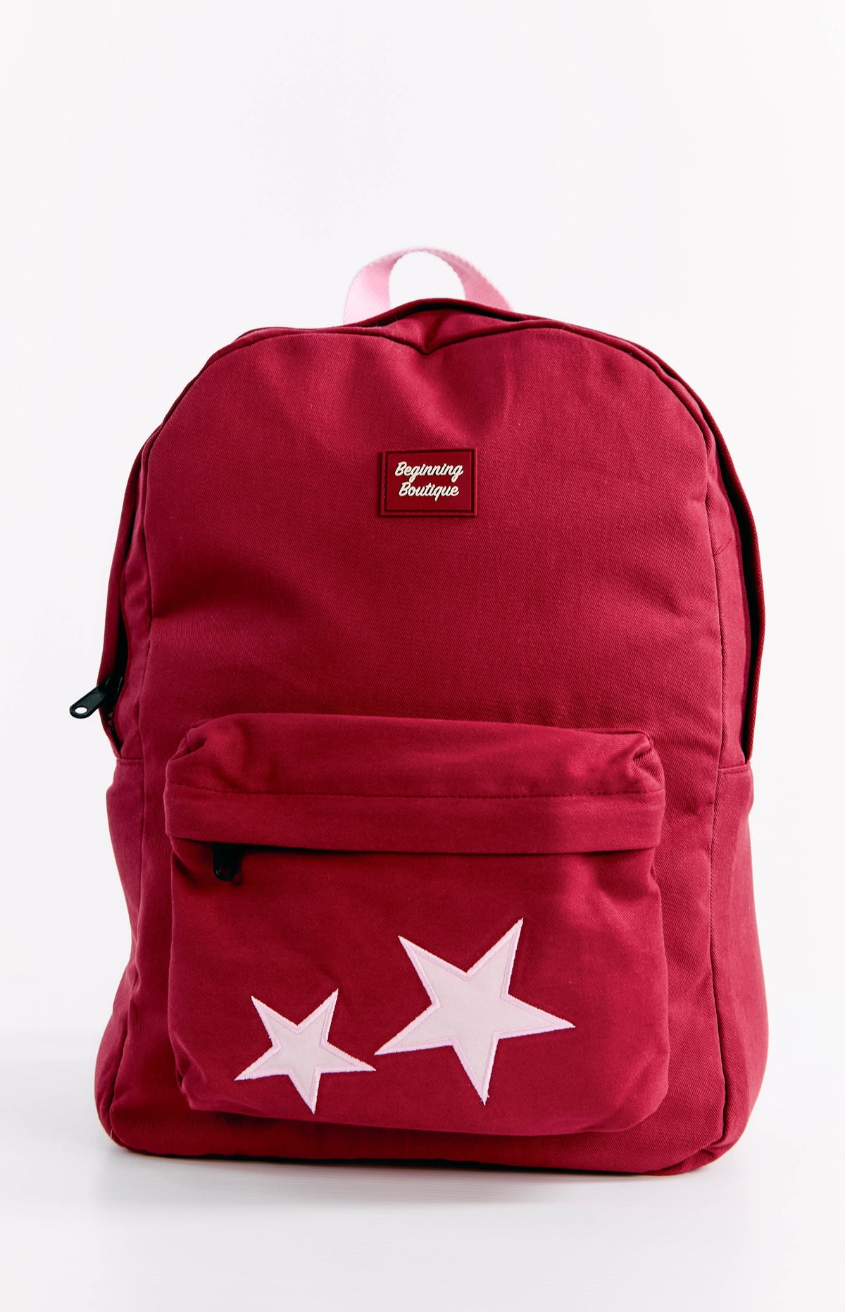 Front view of a burgundy backpack with two light pink stars on the front pocket and a pink top handle