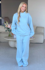 Full length view of light blue mid-rise slouch fit trackpants with a wide leg