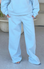 Full length view of light blue mid-rise slouch fit trackpants with a wide leg and soft fabric