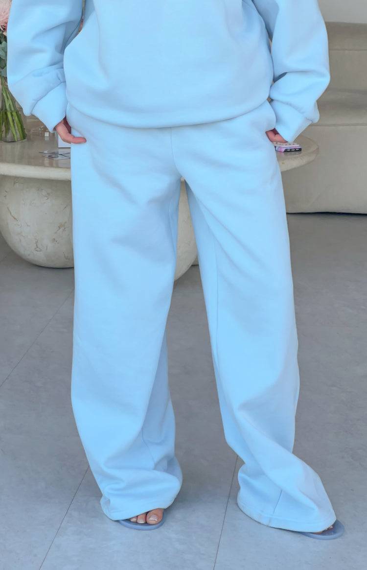 Full length view of light blue mid-rise slouch fit trackpants with a wide leg and soft fabric