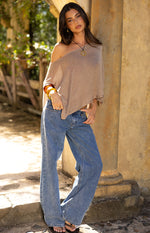 Off-shoulder taupe metallic knit poncho with a loose, asymmetrical drape