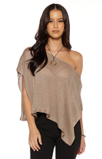 Front view of a champagne metallic knit poncho with an off-the-shoulder neckline and asymmetrical hem