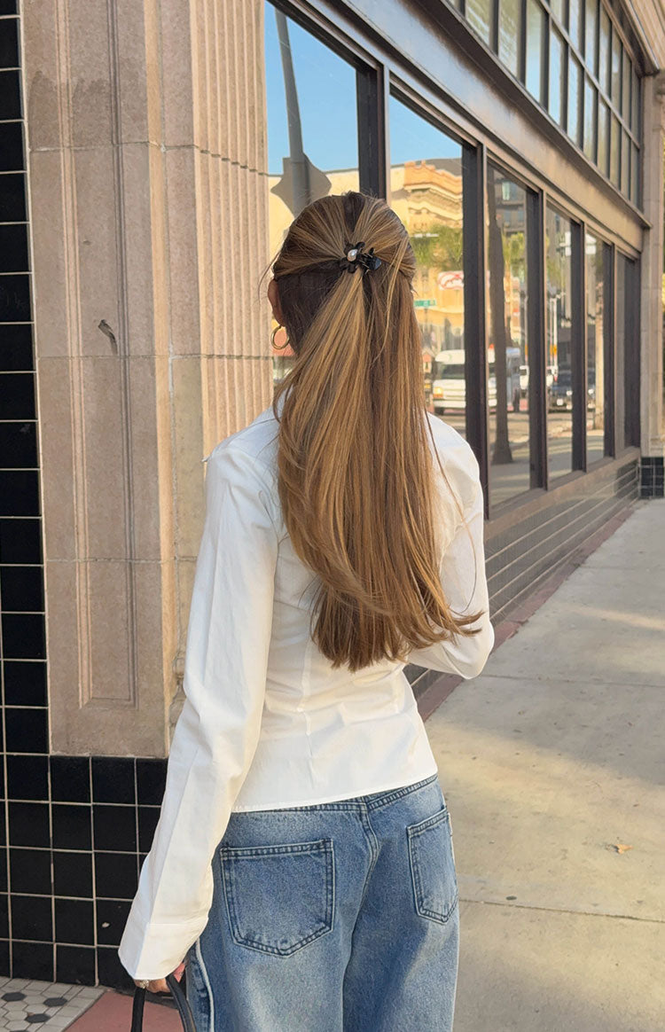 Rear view of mid wash wide leg jeans with large back pockets and contrast stitching