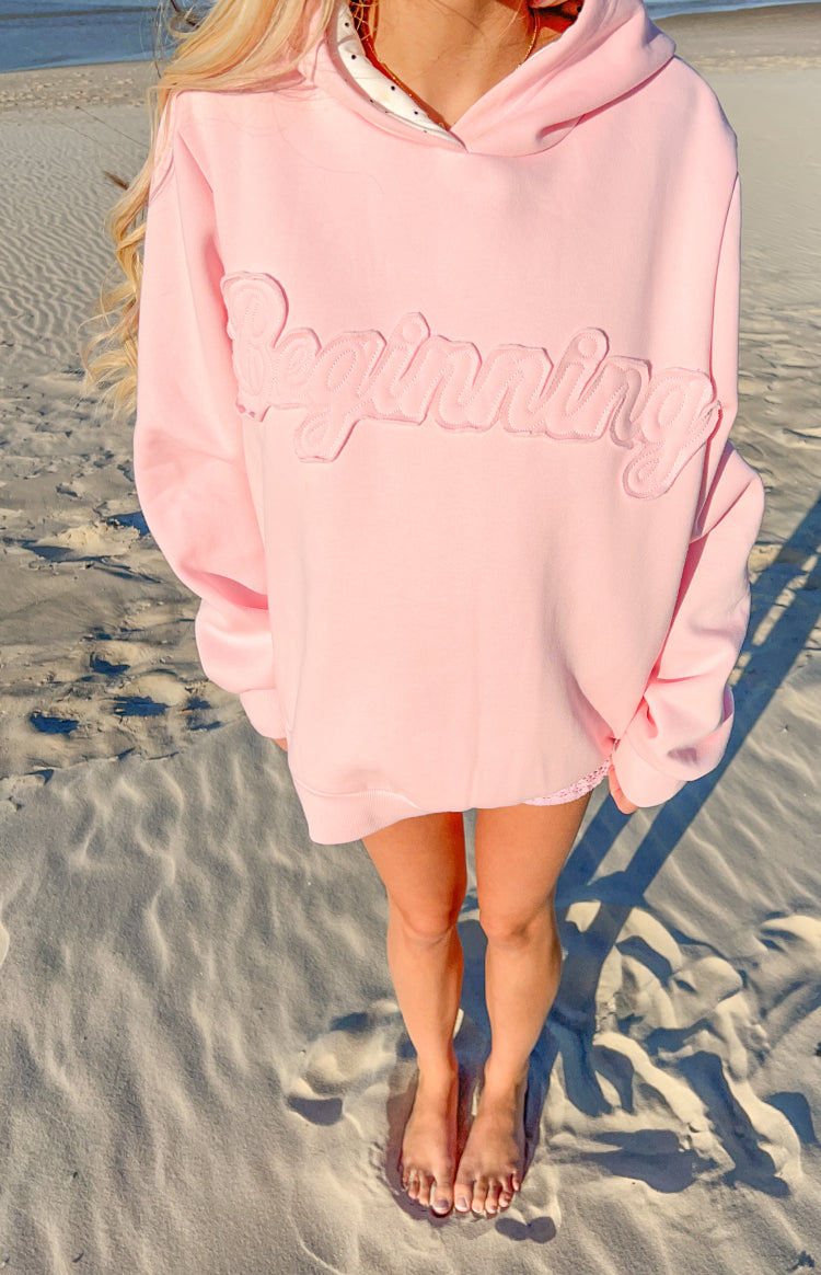 Oversized pink hoodie with 'Beginning' embroidered in script on the chest