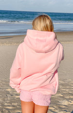 Rear view of a light pink relaxed fit hoodie with a large hood and dropped shoulders