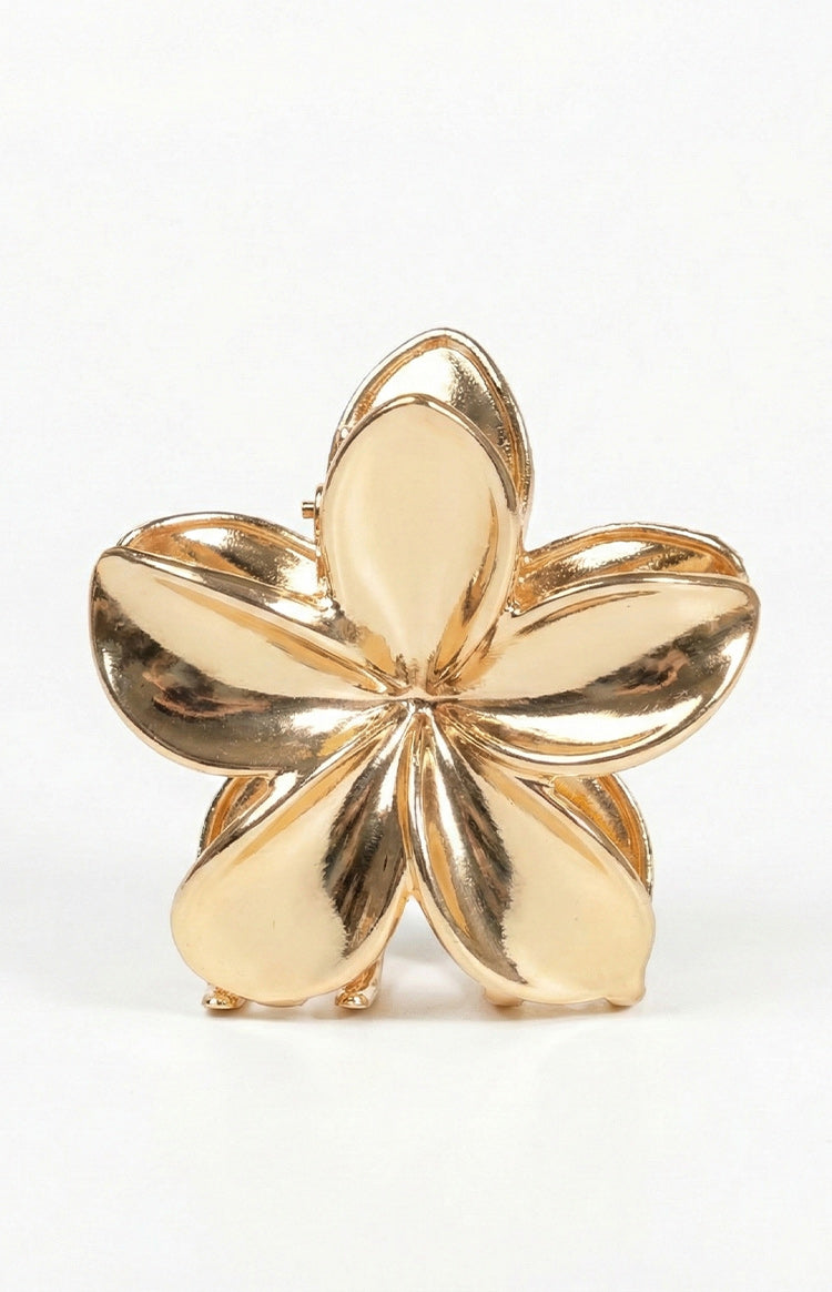Front view of a polished gold metal flower claw clip with five curved petals