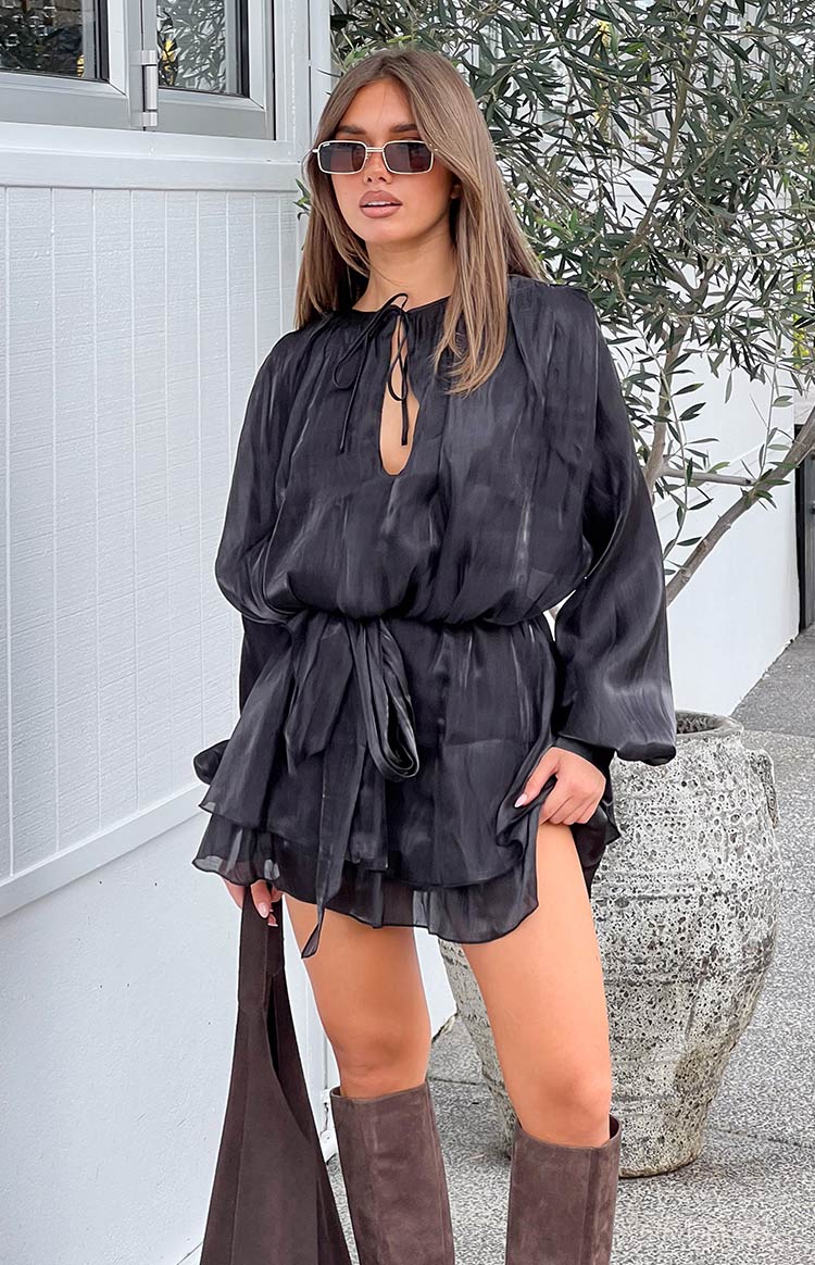 Black satin long sleeve mini dress with a tie-front keyhole neckline, elasticated waist, and tiered ruffled skirt