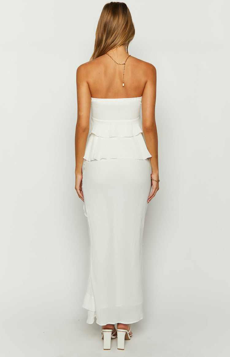 Rear view of a white fitted maxi skirt showing the subtle ruffle detail on the left side