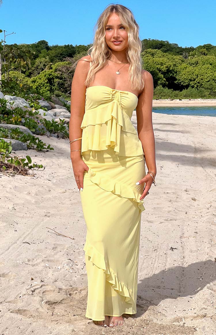 Full length view of a yellow maxi skirt with diagonal tiered ruffles