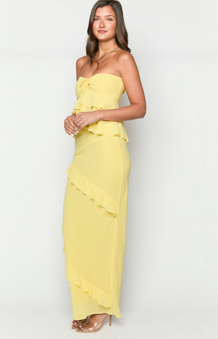 Side view of a yellow ruffle maxi skirt with a diagonal ruffle detail