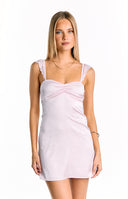A delicate light pink satin mini dress- featuring a softly ruched sweetheart neckline and subtle lace-trimmed shoulder straps- perfect for a romantic or semi-formal occasion.