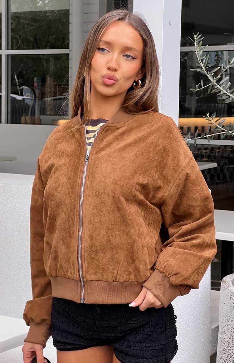 Close-up of the brown suedette bomber jacket showing the silver zipper and ribbed hem and cuffs