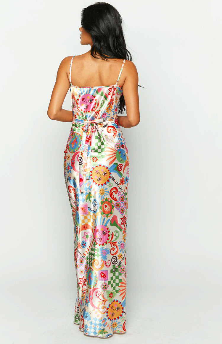Rear view showing the self-tie waist and colourful summer print on a satin maxi dress with spaghetti straps