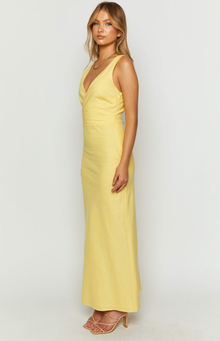 Side view of a yellow linen blend maxi dress with a deep V-neckline and fitted waist