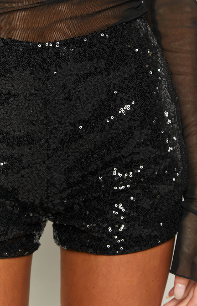 Close-up of the black sequin hot pants fabric, showing the small, densely packed, shimmering sequins