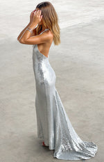 Side view of the silver sequin maxi dress highlighting the low back and flowing train