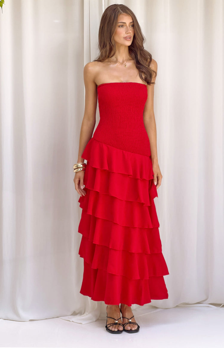Front view of a red strapless maxi dress with a shirred bodice and tiered ruffles starting diagonally