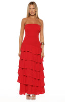 Model wearing a vibrant red strapless maxi dress featuring a smocked bodice and tiered ruffle skirt suitable for a prom