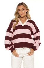 Front view of a pink and burgundy striped knit polo with a white V-neck collar and long cuffed sleeves