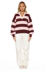 Front view of a relaxed fit pink and maroon striped knit polo with a white V-neck collar and long balloon sleeves