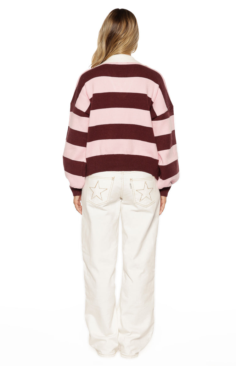 Back view of the oversized pink and maroon striped knit polo with dropped shoulders and ribbed hem
