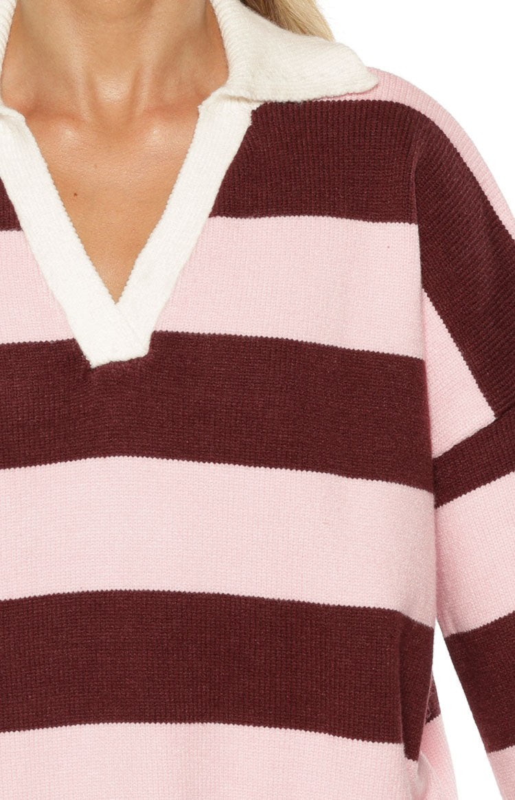 Close-up of the white polo collar and V-neckline on a pink and maroon striped knit polo