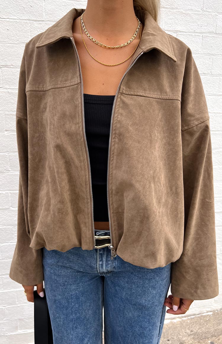 Brown suedette bomber jacket with a partially open silver zipper, collar, and elasticated bubble hem